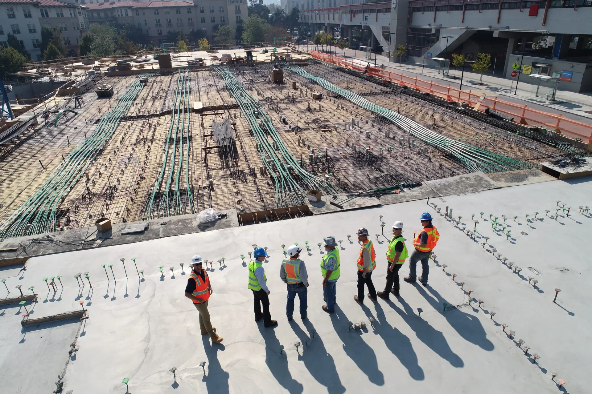 group of civil engineers on top of a building at a construction site