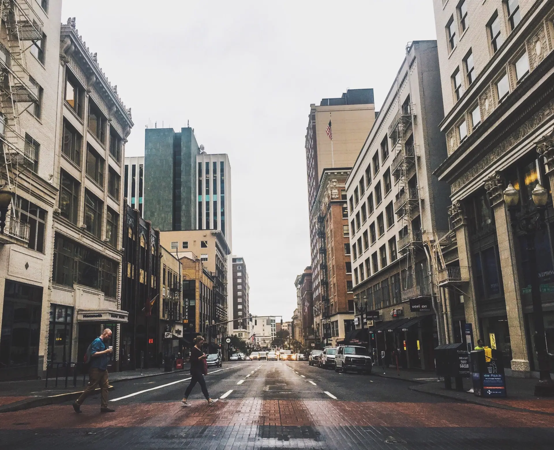 mixed-use buildings downtown and people crossing the street